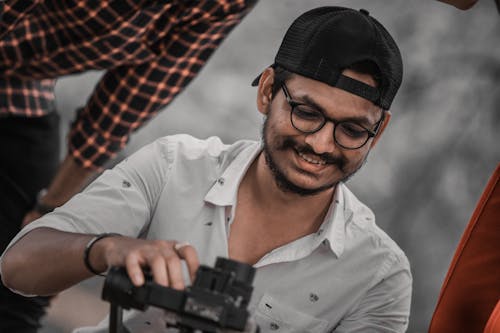 A Bearded Man Smiling while Wearing Eyeglasses