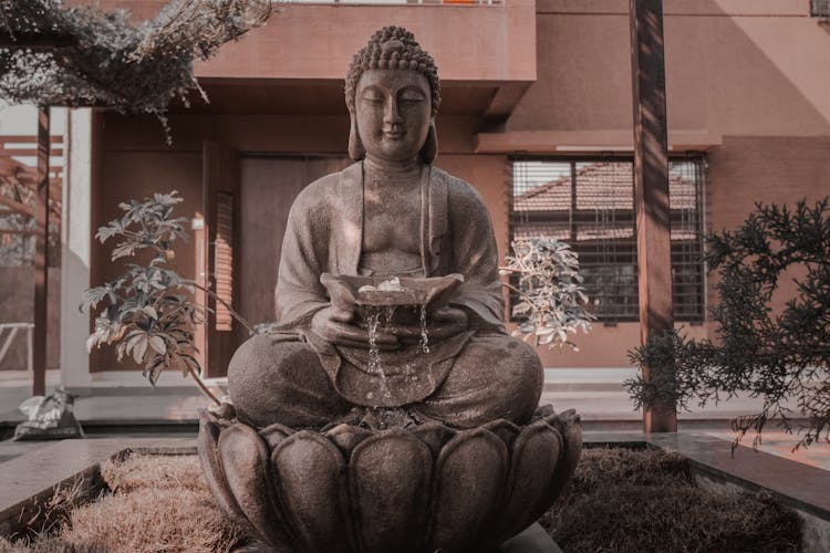 Buddha With Water Fountain At A Garden