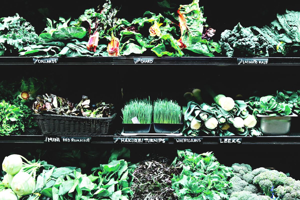Market display of varied fresh vegetables and herbs supporting the 30 plants a week target for vegan gut health