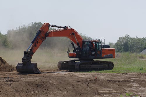 Excavator Leveling the Ground