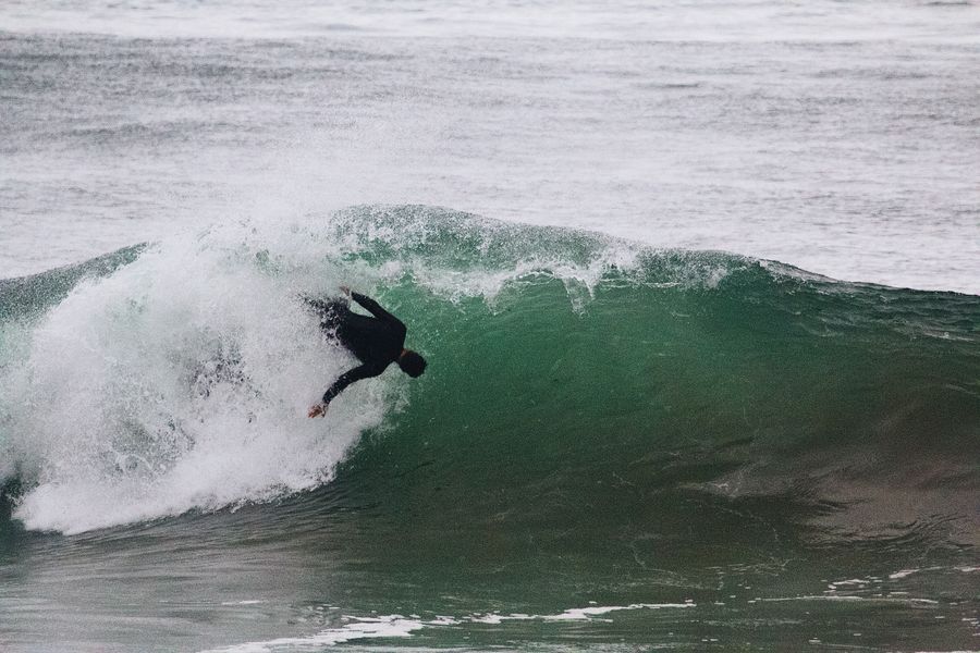 Surfer riding a green wave