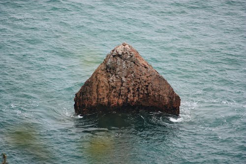 Free A Rock Formation on the Body of Water Stock Photo