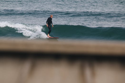 A surfer in a wetsuit skillfully rides a wave on the open ocean.