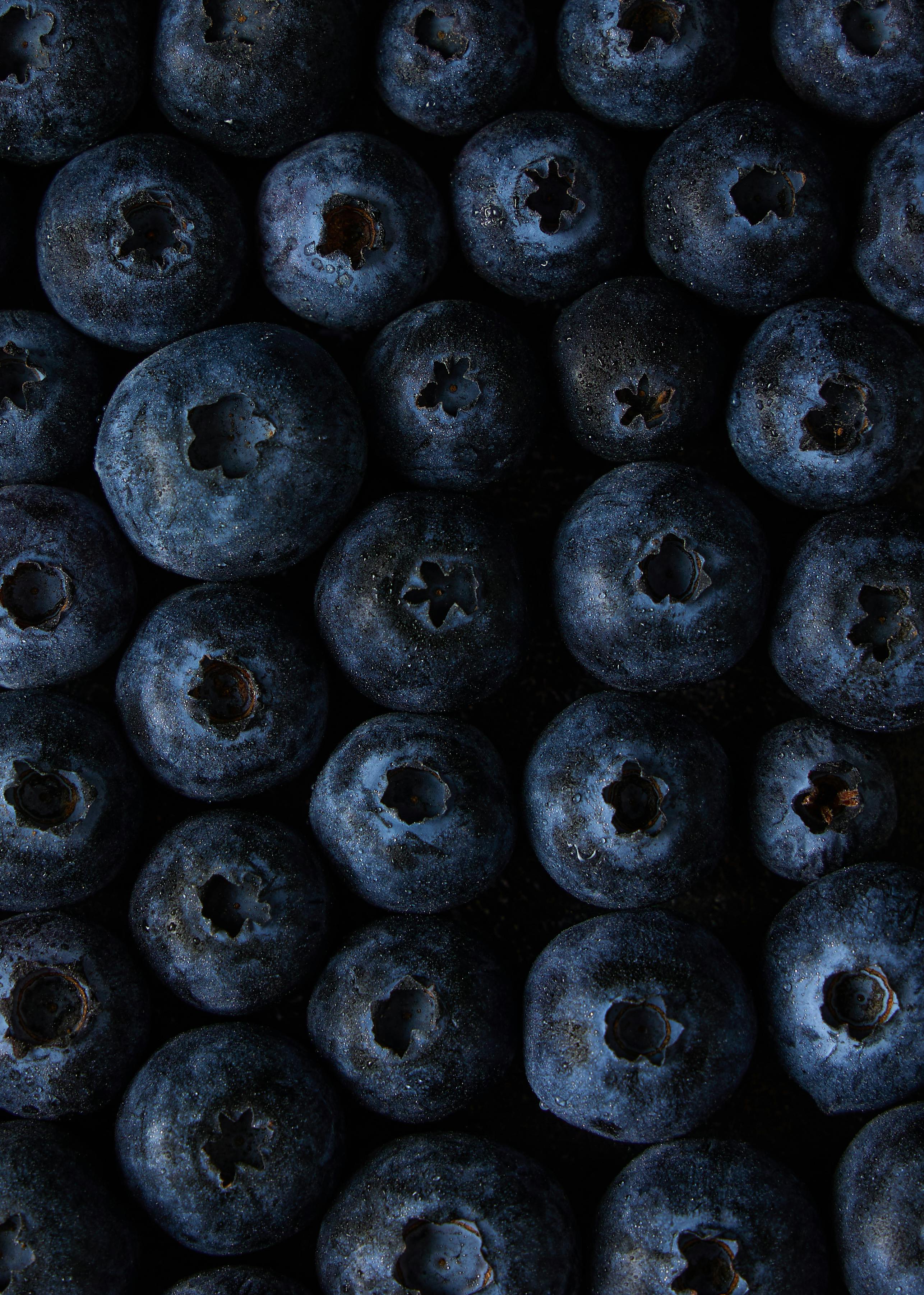 A captivating close-up photo of fresh blueberries, showcasing their deep blue color and texture.