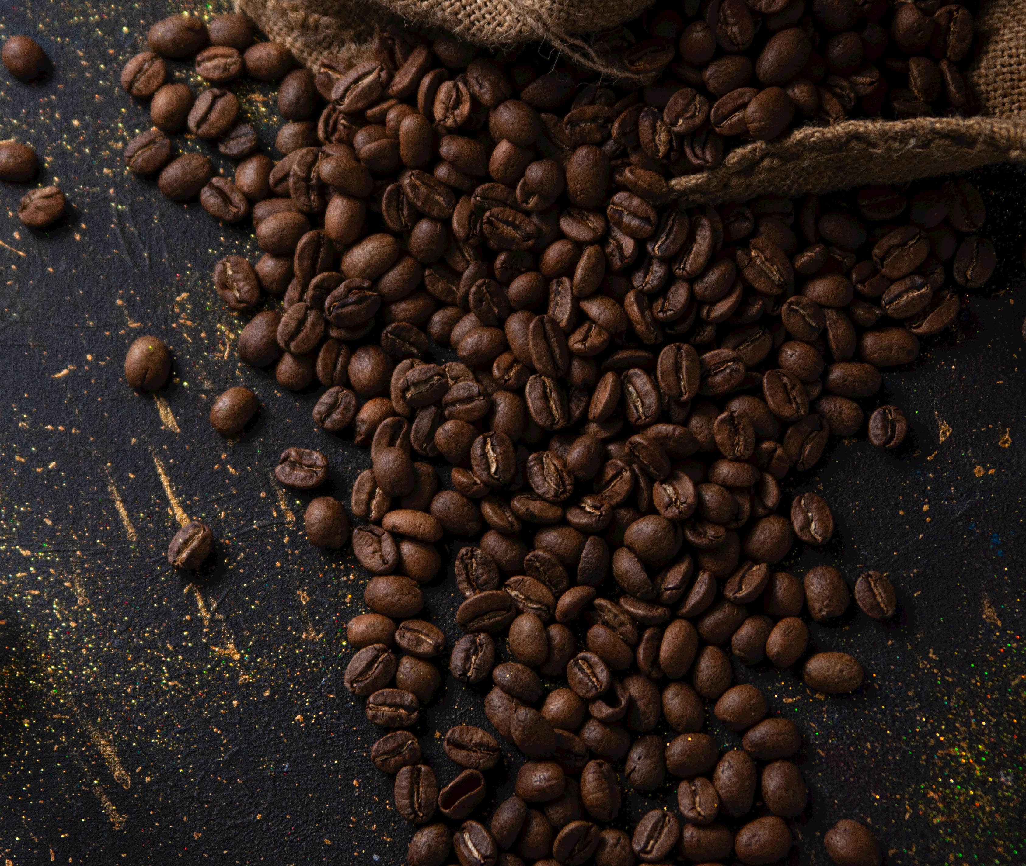 close up of coffee beans on a black table