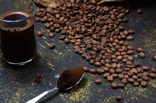 Free Close-Up Shot of Roasted Coffee Beans on Black Surface Stock Photo