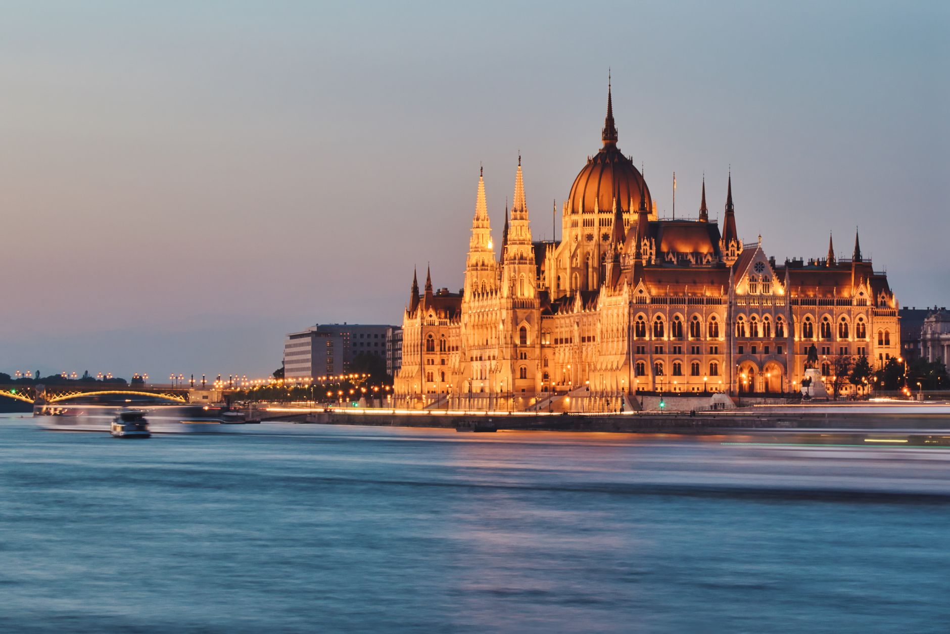 Stunning view of Budapest's Parliament building by the Danube River at twilight.
