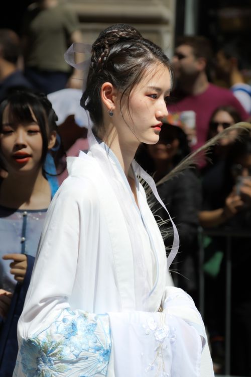 Free Side view of a young woman in traditional Hanfu attire at a cultural event in New York City. Stock Photo