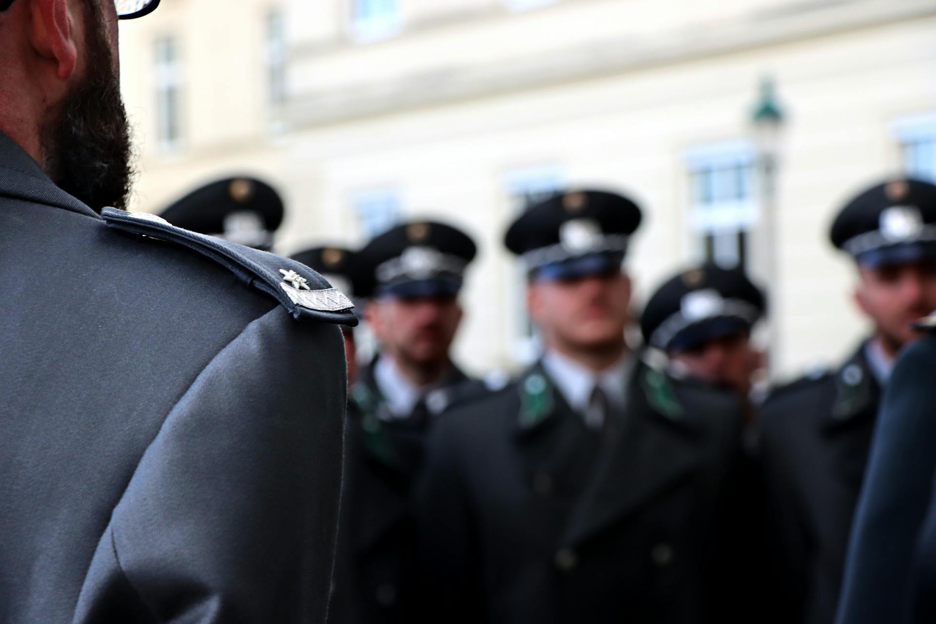 Sergeant Insignia on the Shoulder of a Man Standing in Front of the Unit in Dress Uniforms