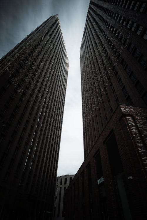 Free Low Angle Shot of Buildings Touching Sky Stock Photo