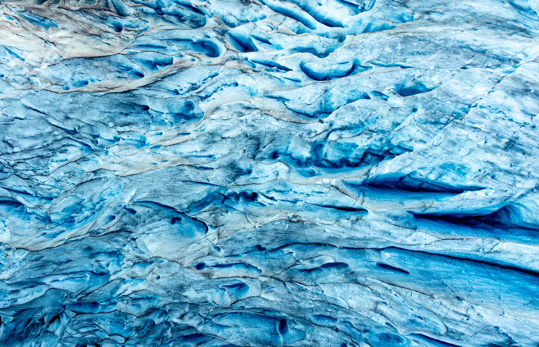 A detailed close-up of vivid blue glacier ice texture showcasing natural patterns.. detailed, close, vivid