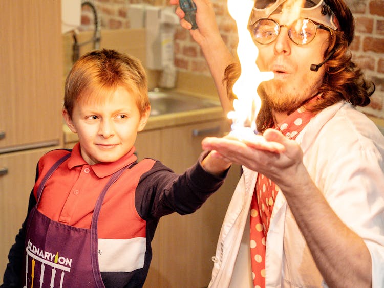 Man And Boy Doing Tricks With Fire