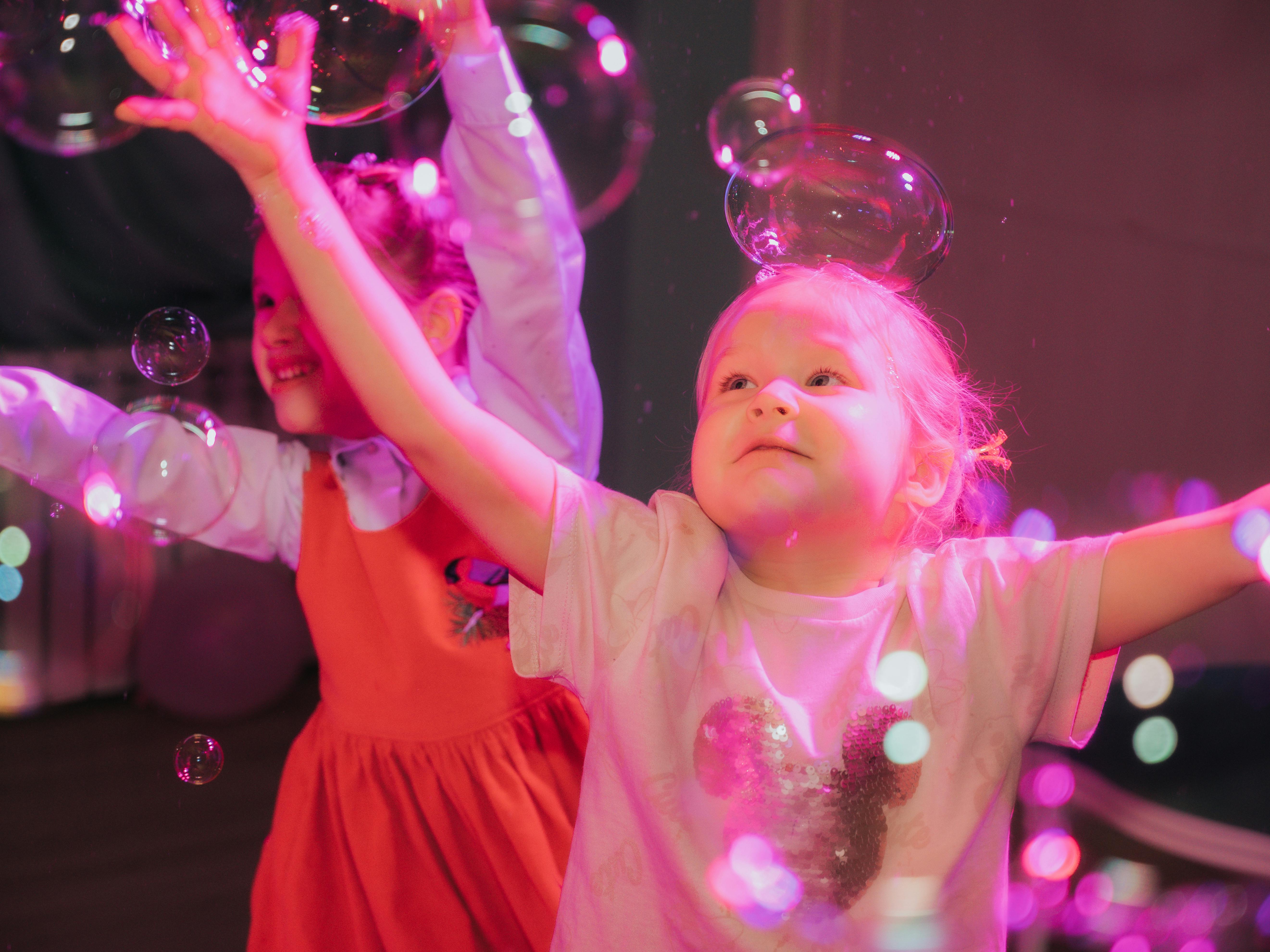 young girls playing bubbles