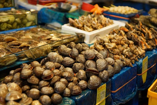 Assorted shellfish and seafood displayed at a bustling Korean wet market in Hoengseong-gun.