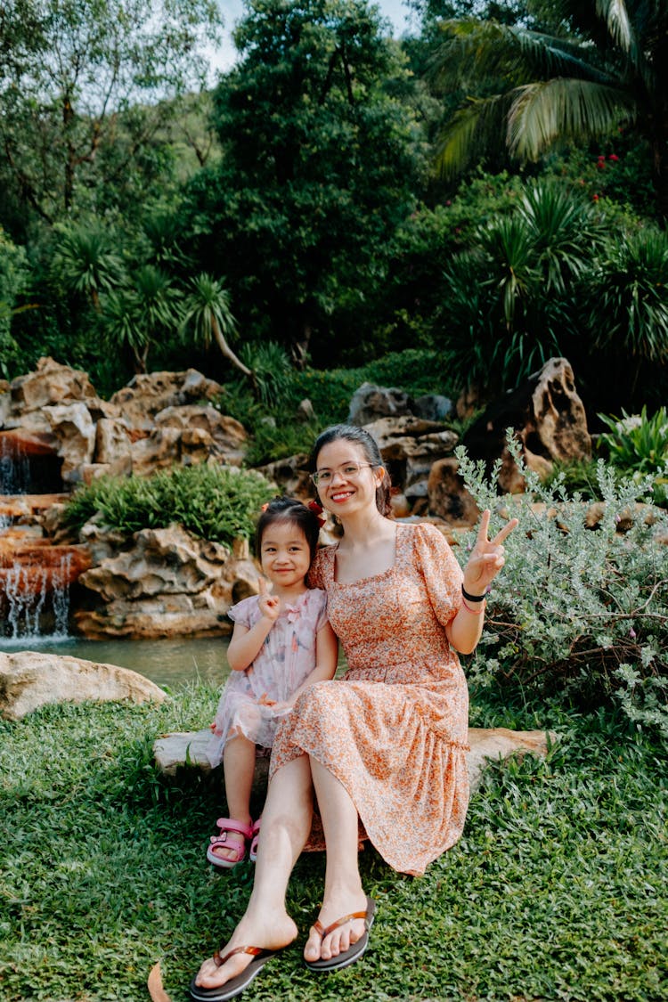 Mother And Child Posing On A Garden