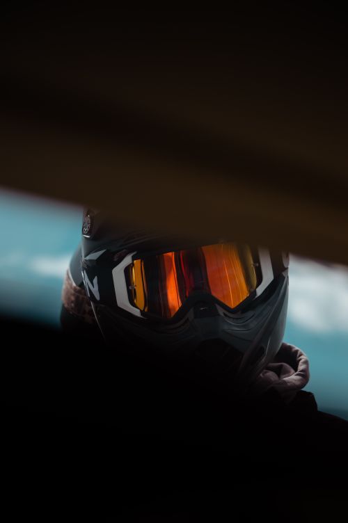 Free Close-up shot of a motorcyclist wearing a reflective helmet, creating a mysterious and adventurous mood. Stock Photo
