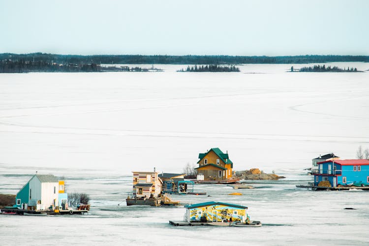 Winter Landscape With Houses On Platforms 