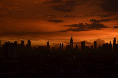 Free Silhouette of Jakarta's skyline at sunset with dramatic red sky and skyscrapers. Stock Photo