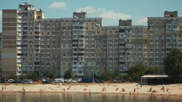 People On Beach Near High Rise Buildings