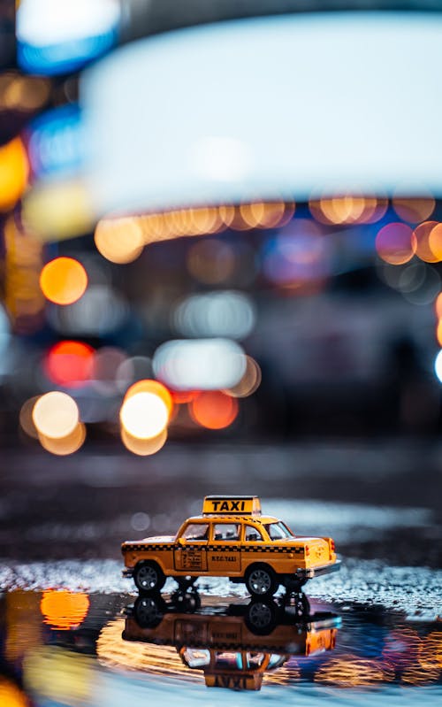 Free Yellow and Black Taxi Cab on Road during Night Time Stock Photo