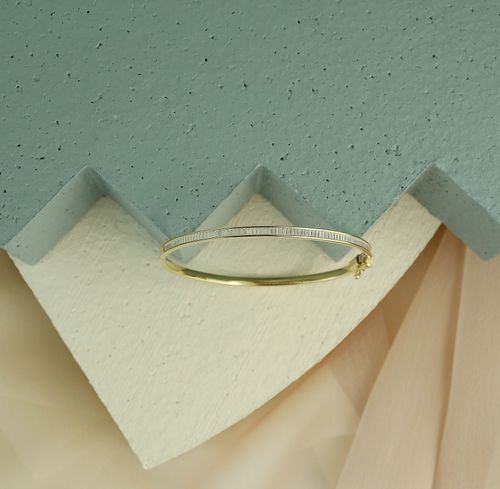Free Minimalist gold bracelet displayed on a pastel geometric surface. Stock Photo