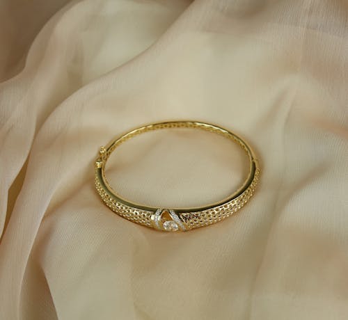 Close-Up Shot of a Gold Bracelet 