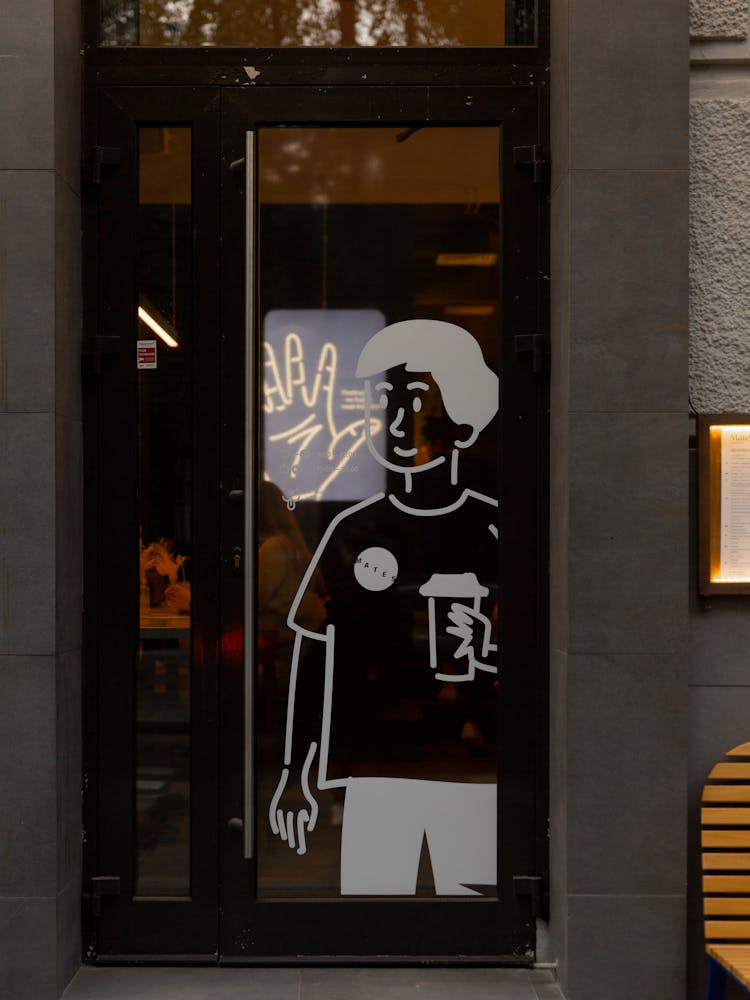 Image Of A Boy Painting On Glass Door