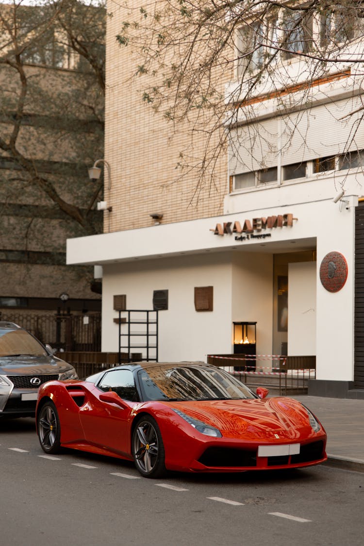 Red Ferrari Parked On The Road