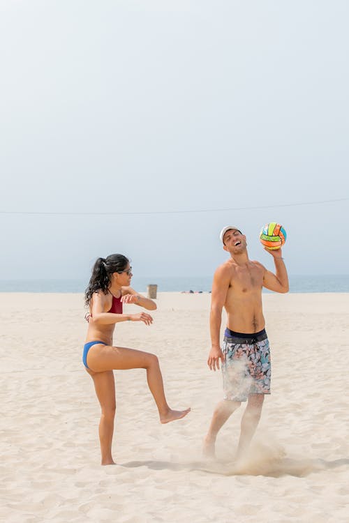 People Having Fun Playing Beach Volleyball 