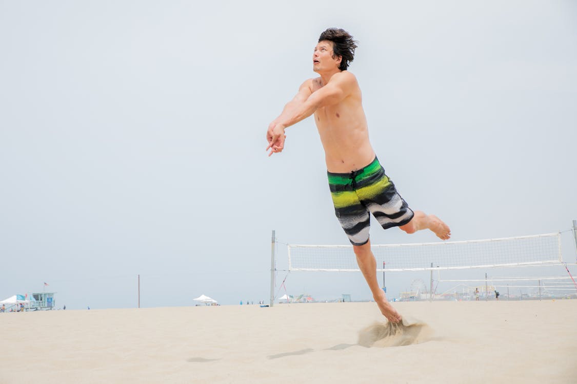 Ball Player Jumping to Take Ball on Hands