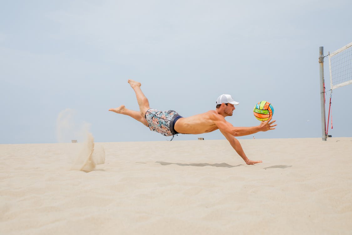 Man Midair Playing Beach Volleyball 