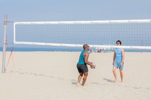 Men Playing Beach Volleyball 