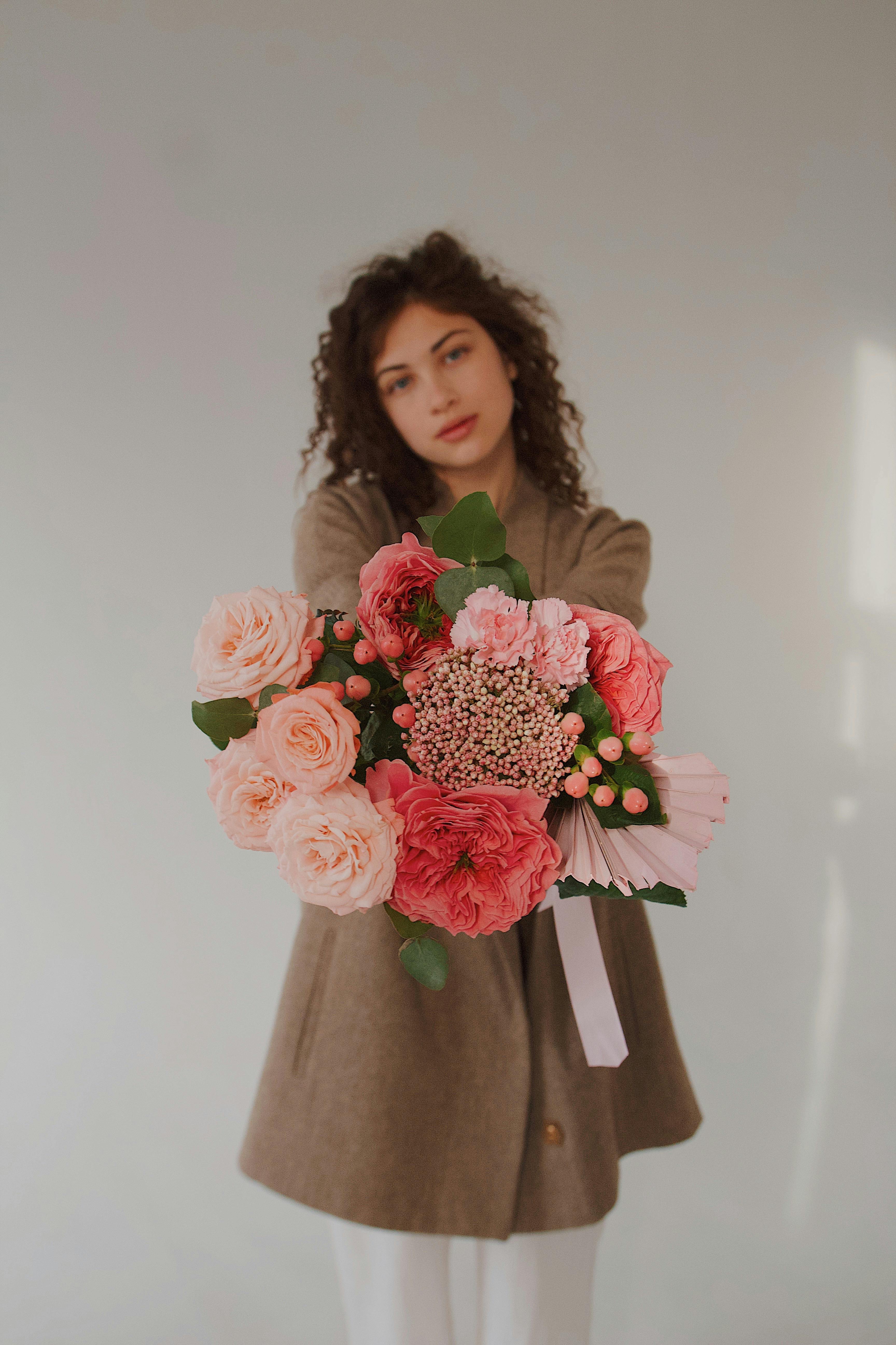 A Woman Holding a Bouquet of Flowers · Free Stock Photo