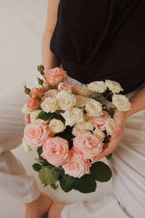 Woman Holding Bunch of Flowers