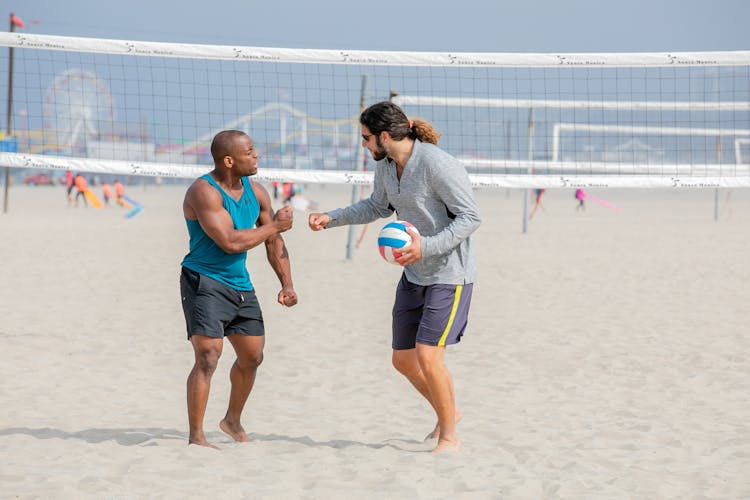 Two Beach Volleyball Giving Fist Bump Gesture