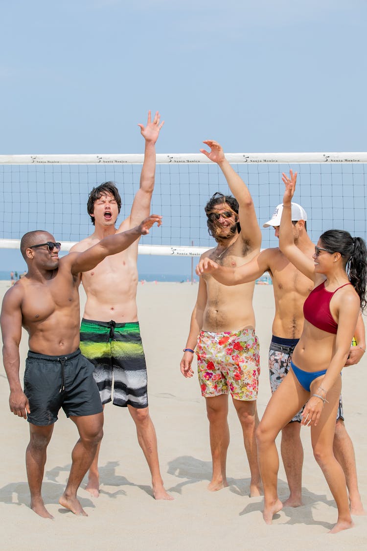 Beach Volleyball Team Performing A Motivational Activity