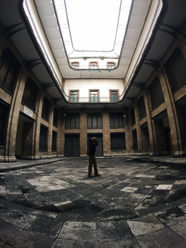 Photographer capturing the architecture in a historic courtyard in Ciudad de México.