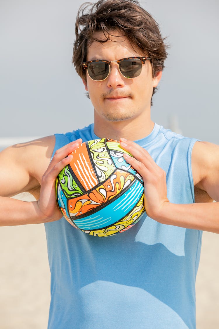 Man In Sunglasses With Ball On Beach