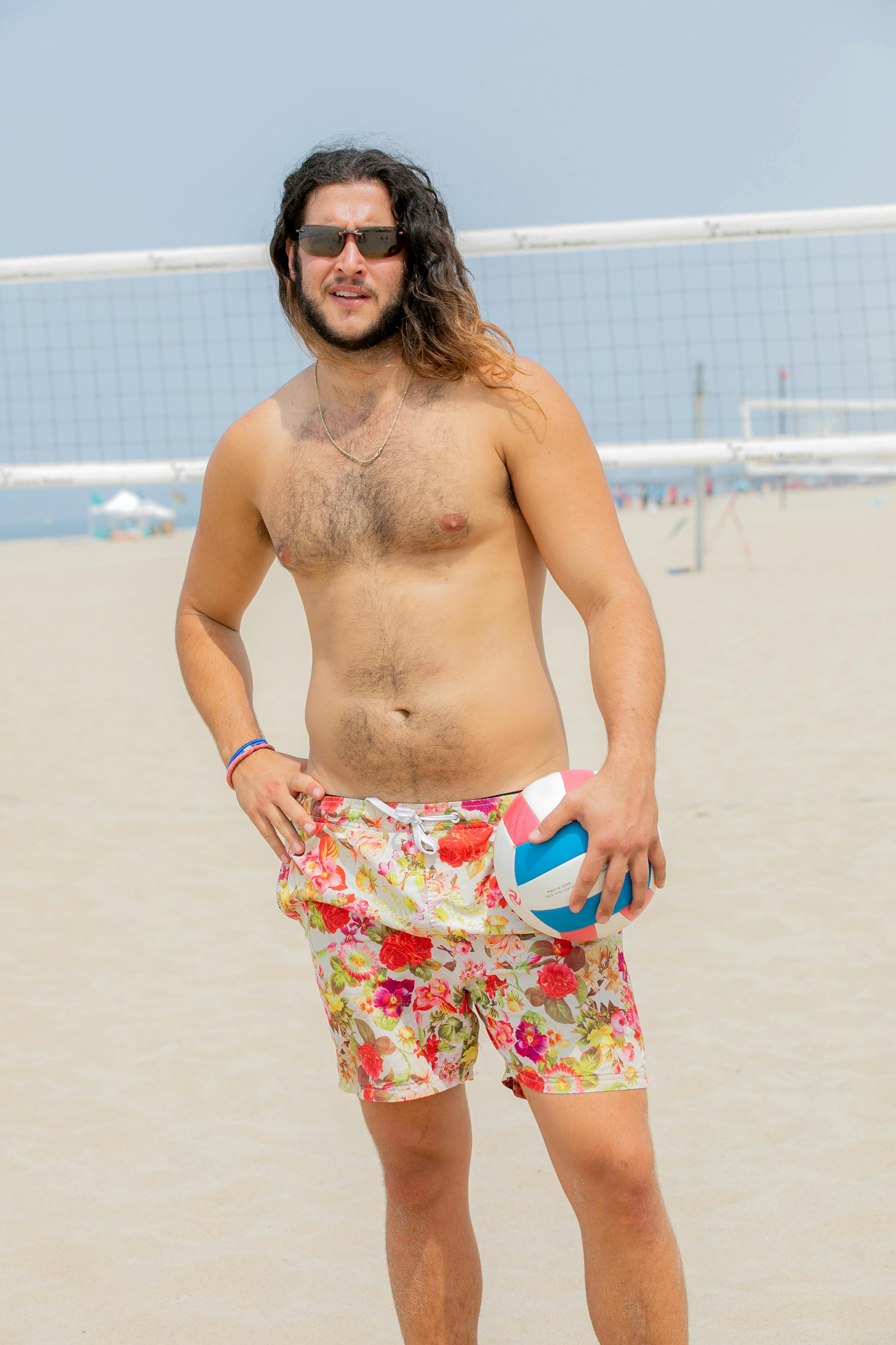 Shirtless Man with Long Hair on Sandy Beach · Free Stock Photo