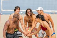 Group of People Sitting on Beach Shore