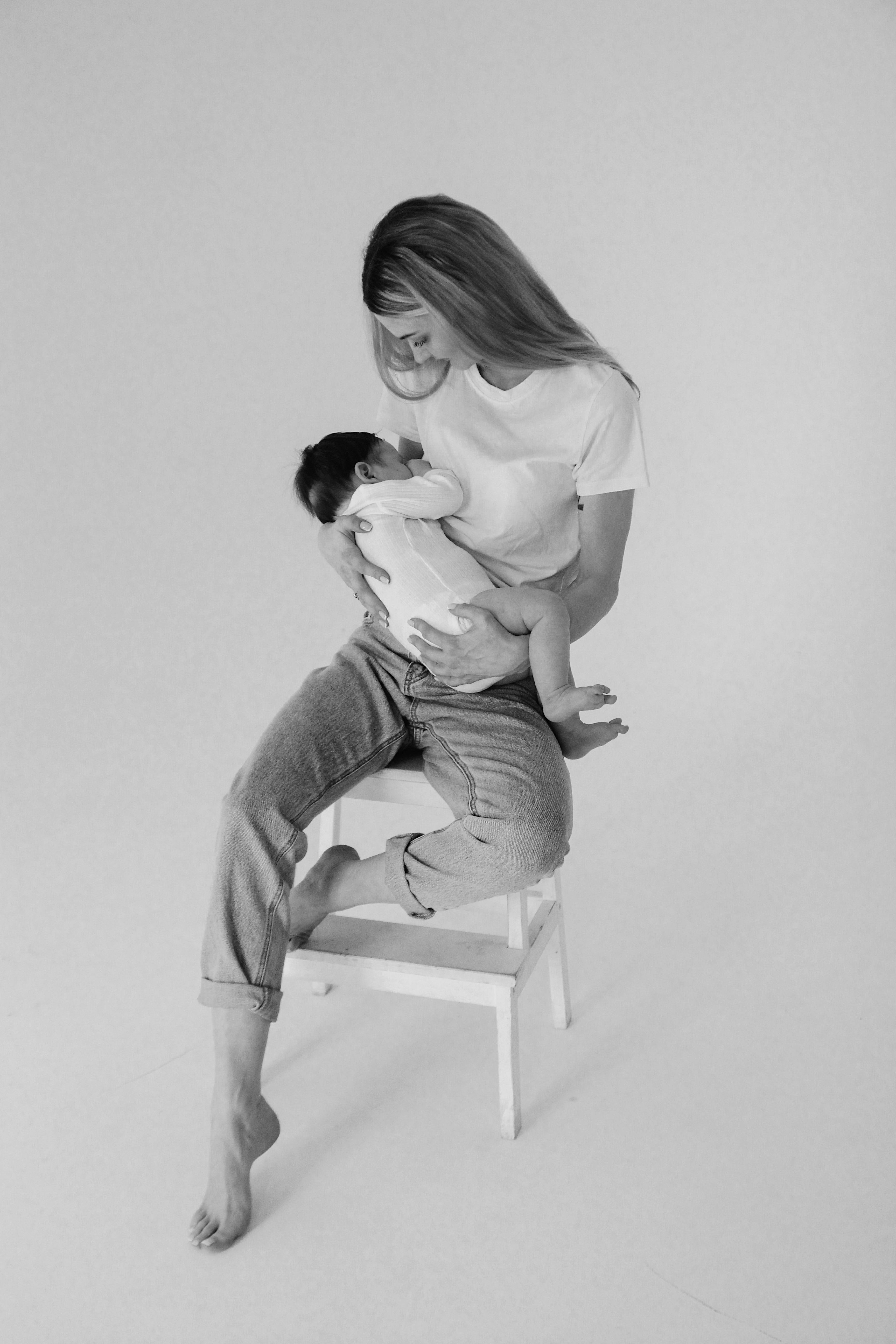 black and white photo of woman holding a baby