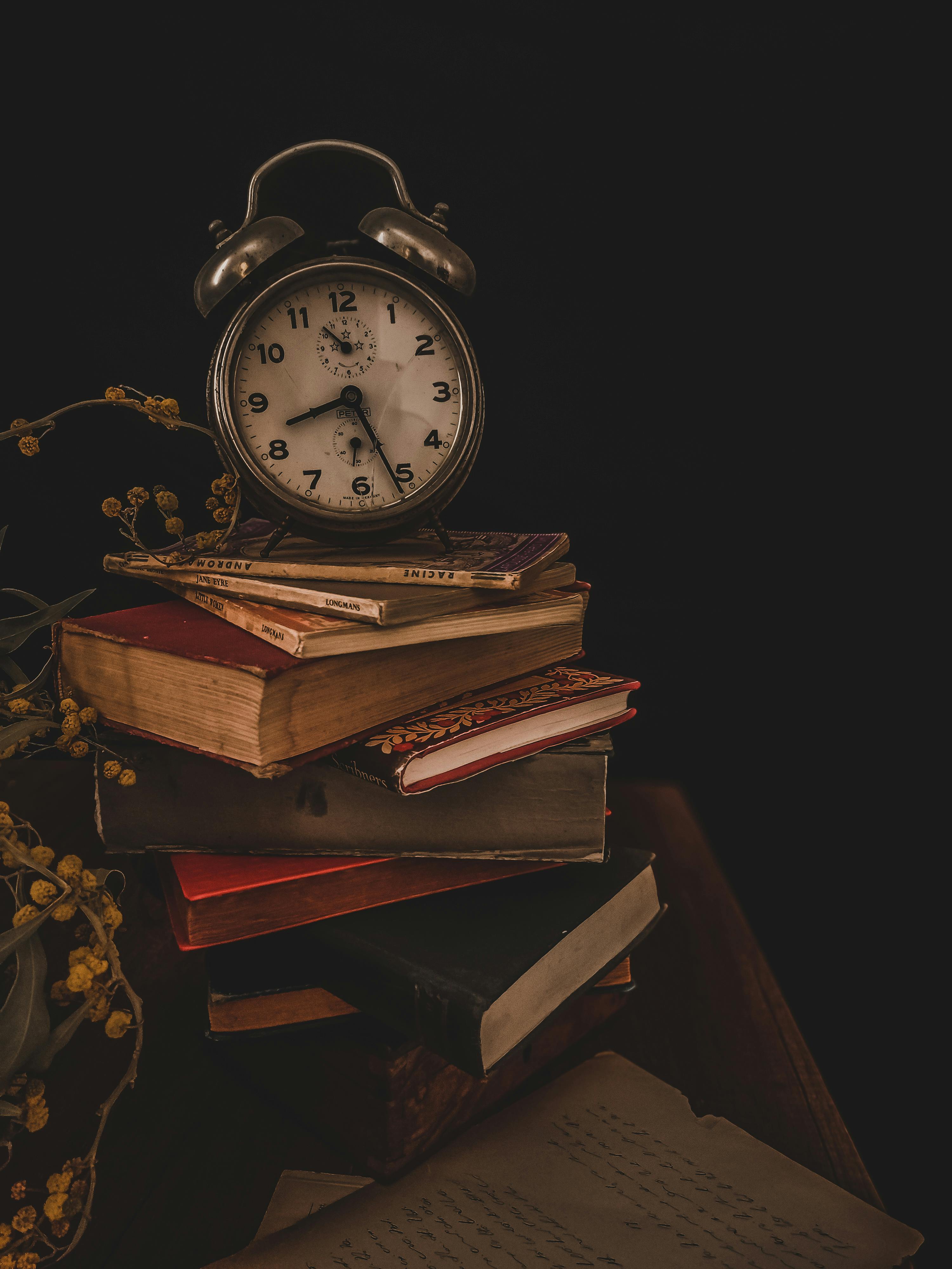 Photo of an Alarm Clock on Top of Books · Free Stock Photo, image size:3000x4000