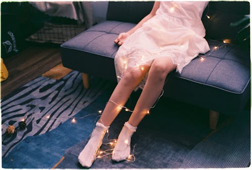 A Woman's Feet Entangled with String Light