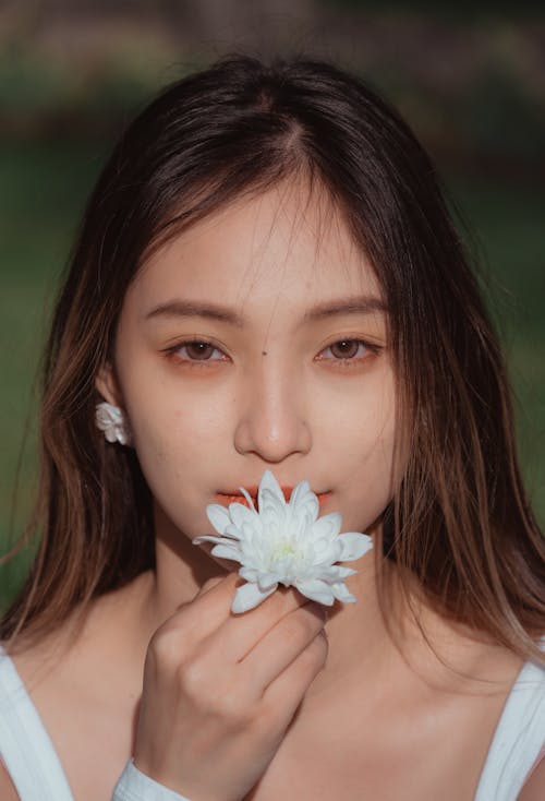 A Woman Holding a White Flower