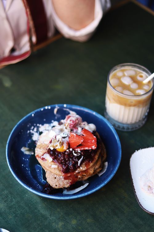 Free Stack of pancakes with fruit and marshmallows served in a Berlin café with coffee. Stock Photo