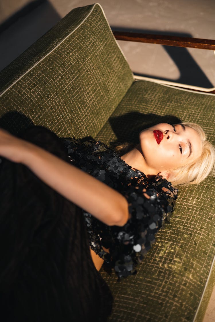 Woman Lying On A Vintage Sofa In A Sequin Top