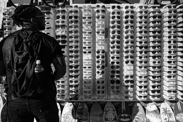 Man Standing Before Sunglasses Display