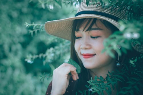 Woman Posing Next To Plant