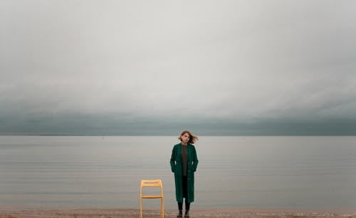 Free Woman Standing Beside Chair  Stock Photo