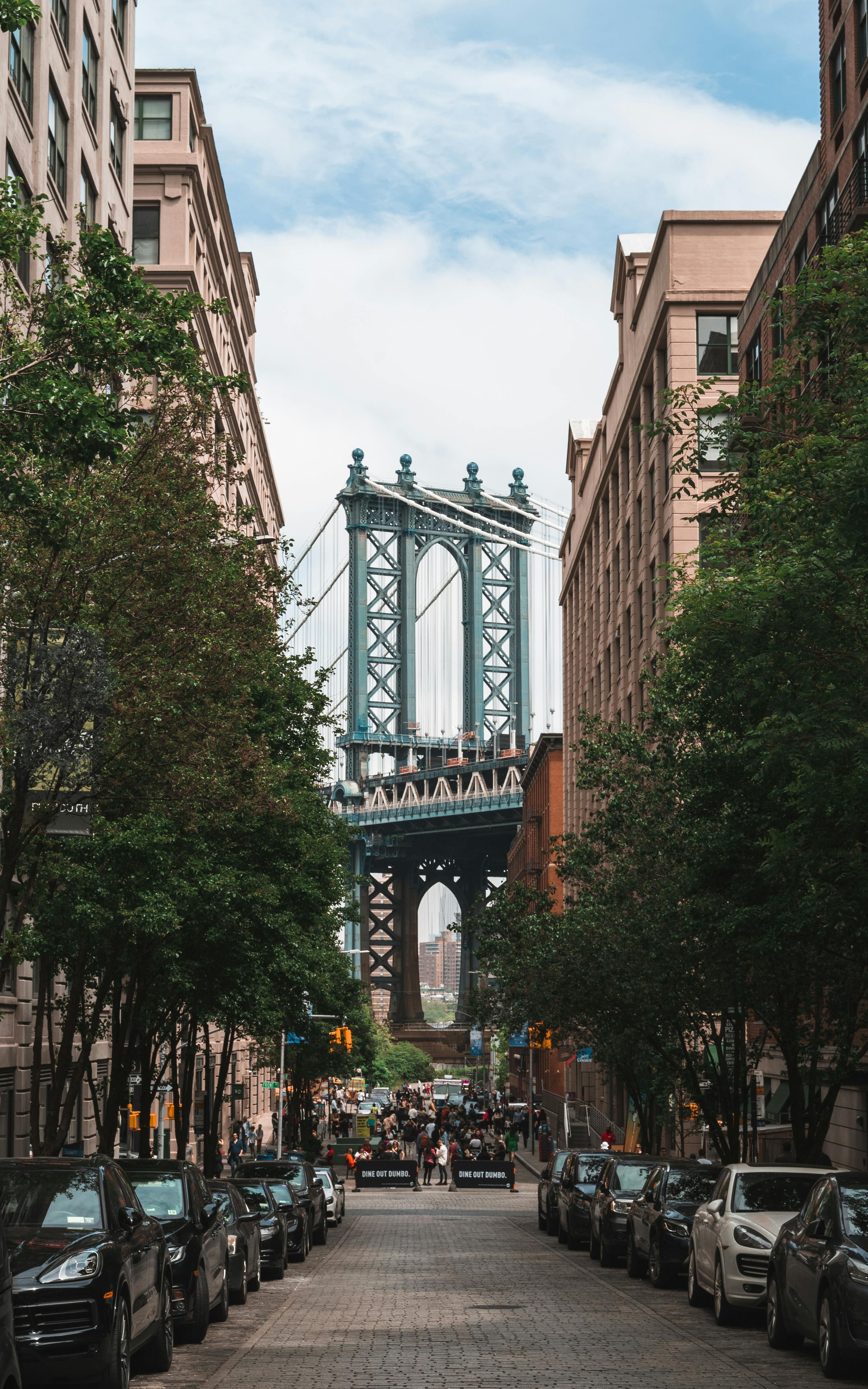 Captivating urban scene of Manhattan Bridge framed by city buildings in Brooklyn.
